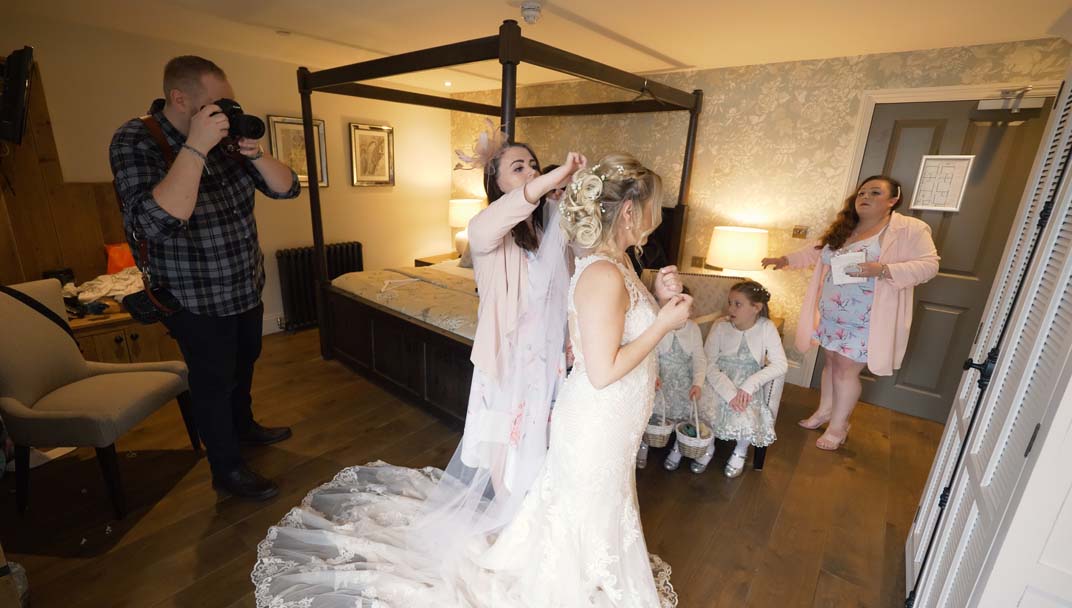 Bride having photo taken whilst getting ready for wedding