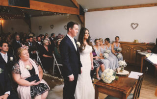 A couple getting married in a civil wedding ceremony at Maiden's Barn, Essex, UK