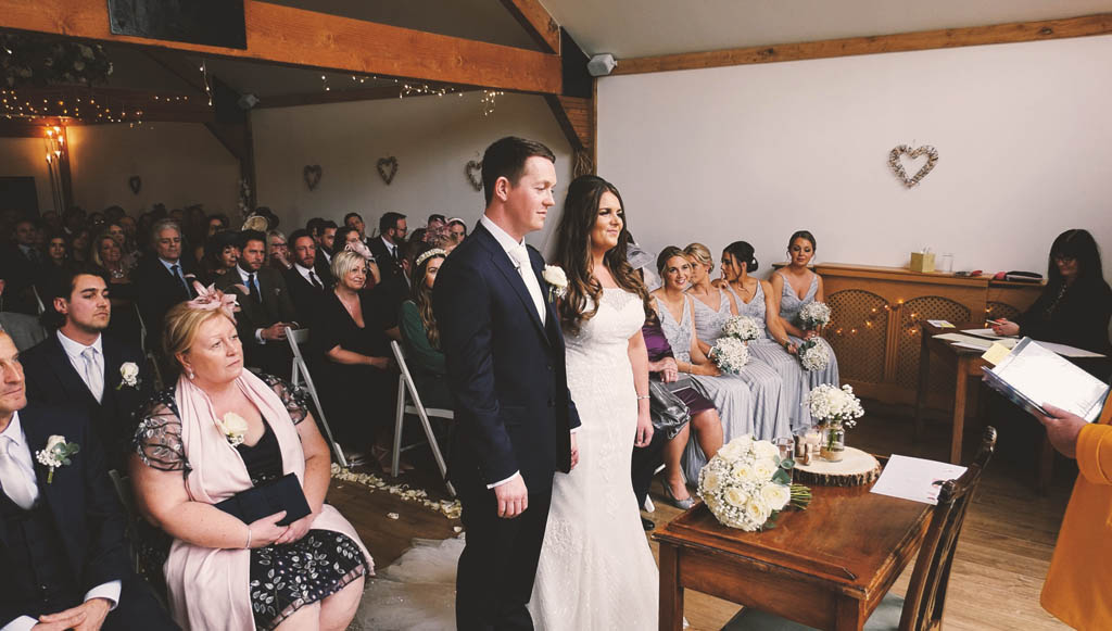 A couple getting married in a civil wedding ceremony at Maiden's Barn, Essex, UK