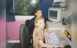 A young Ryan & Carrie play working in an office