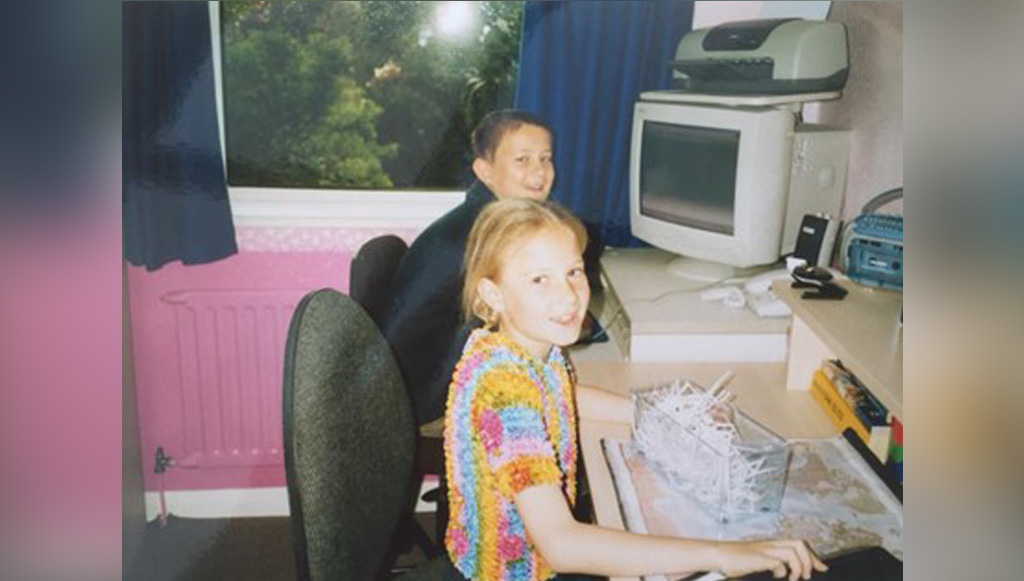 A young Ryan & Carrie play working in an office